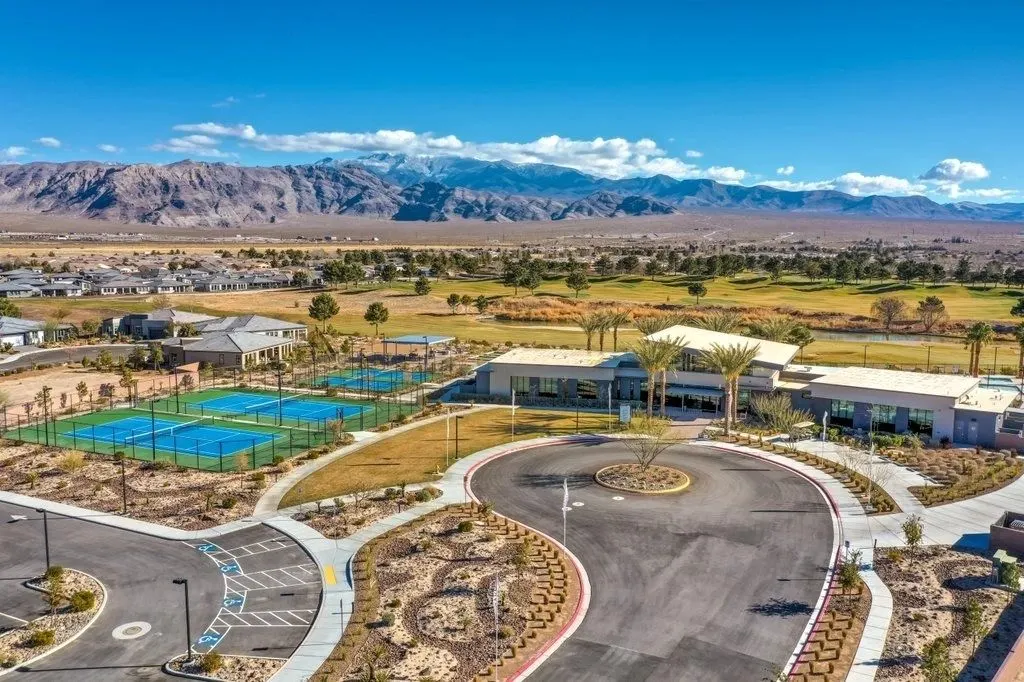 Aerial view of a clubhouse, courts and a quiet roundabout under the Spring Mountains